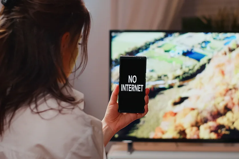Person with no internet connection watching TV